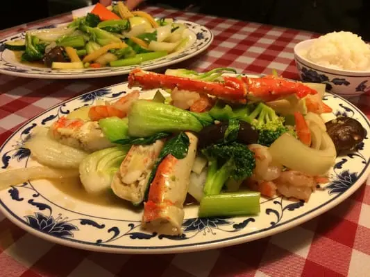 Seafood plate with king crab, shrimp and vegetables over noodles