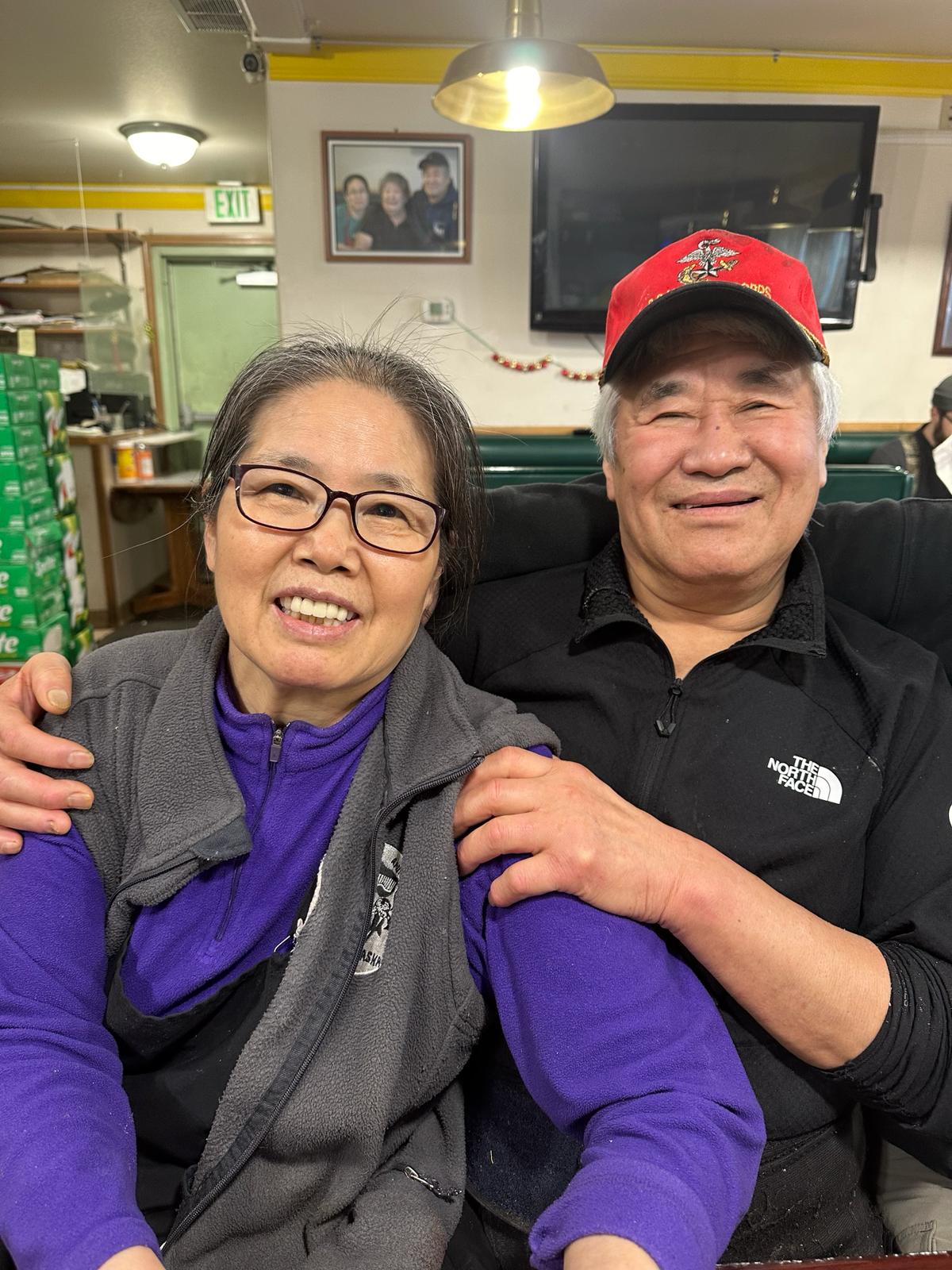 Mr. and Mrs. Kim seated together in the dining room