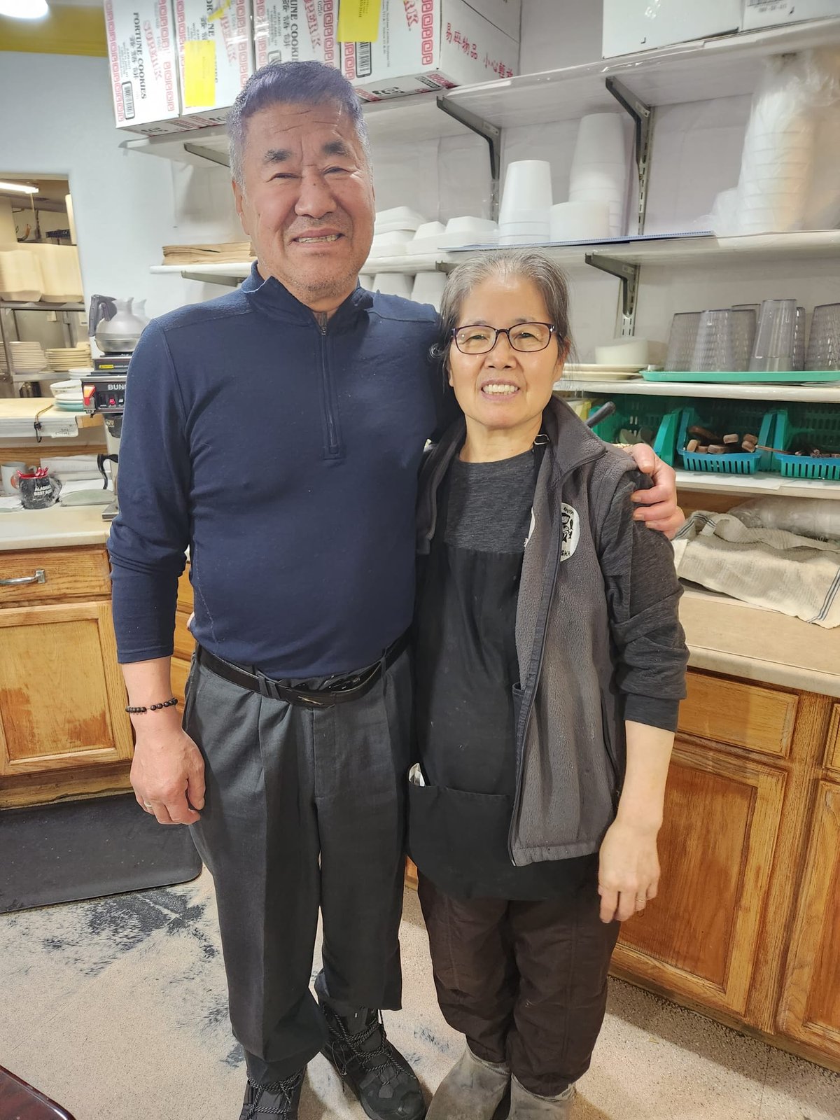 Mr. and Mrs. Kim together in the kitchen at Sam and Lee's Restaurant